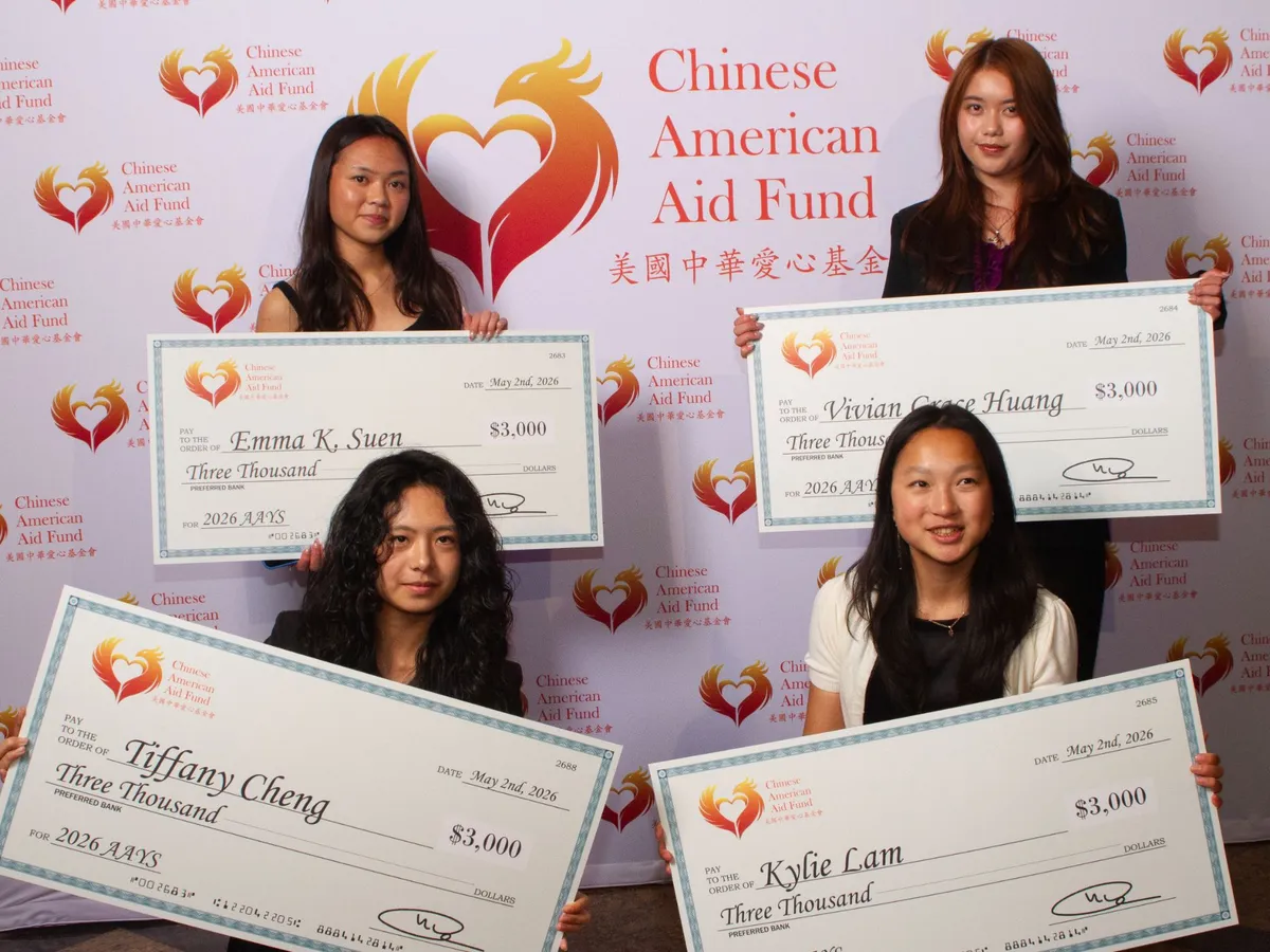 Four 2026 scholarship recipients holding their $3,000 award checks at the gala.
