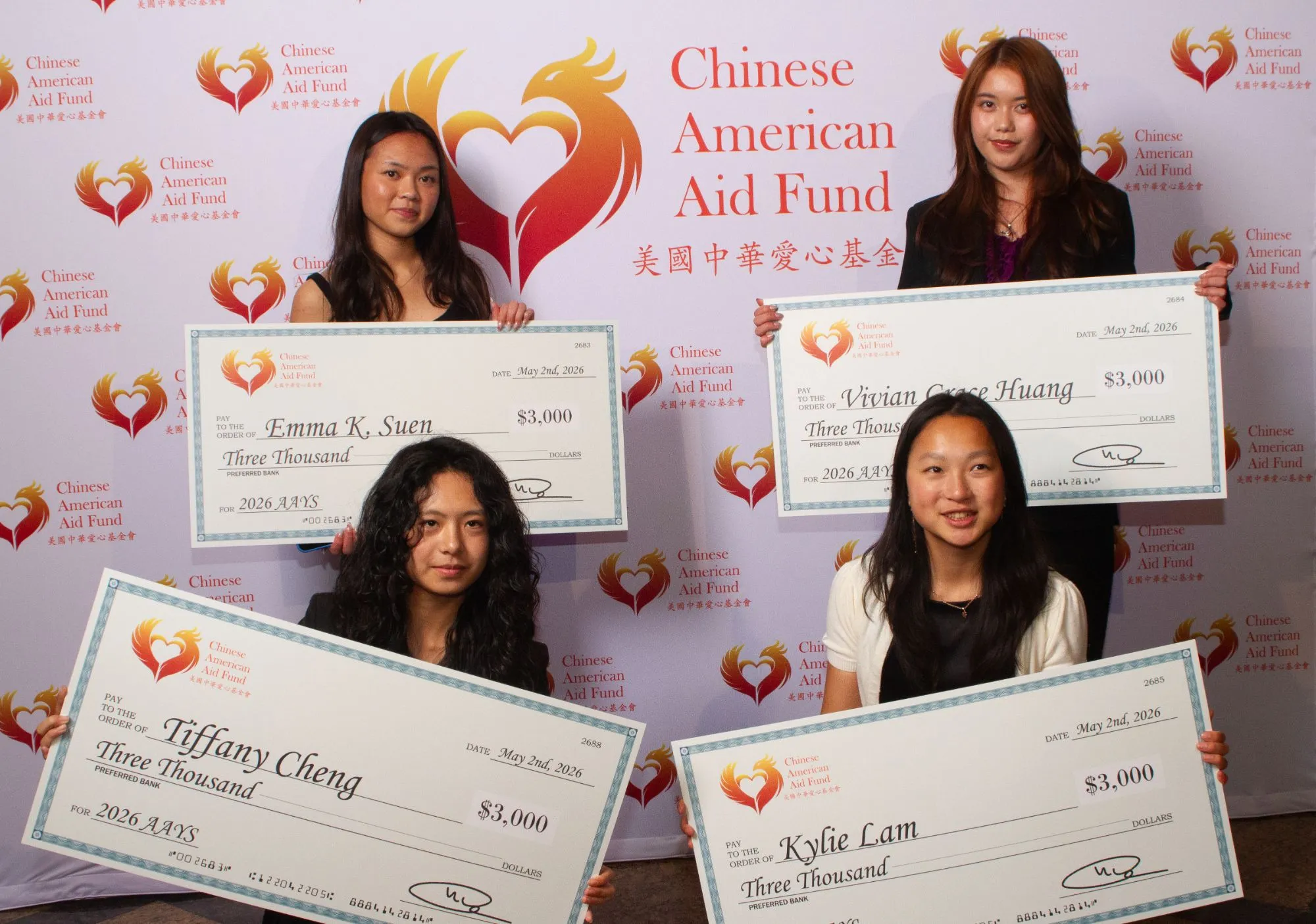 Four 2026 scholarship recipients holding their $3,000 award checks at the Visionaries of Tomorrow Gala.