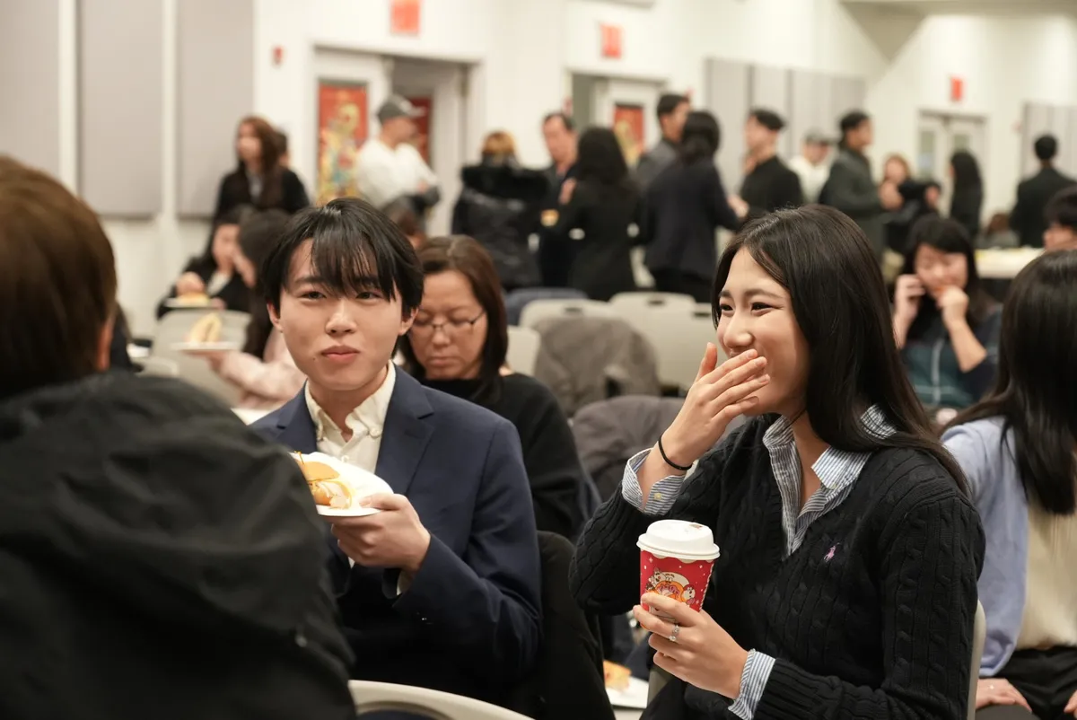 Two students talking and laughing over lunch at the competition.