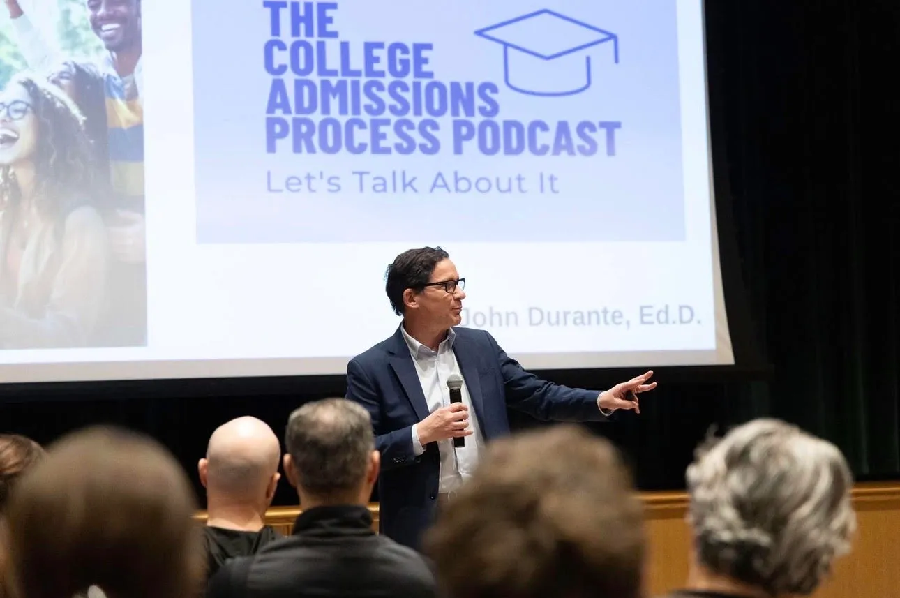 John Durante speaking to a full auditorium about the college admissions process.